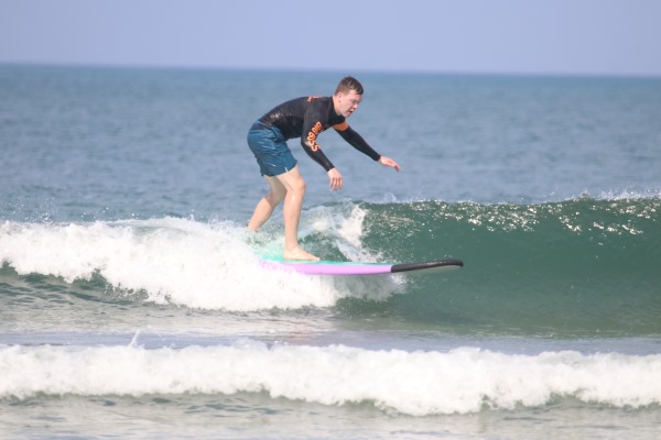 Photograph of Colton surfing in Bali, Indonesia.